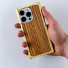 brass zebra wood iphone case in hand